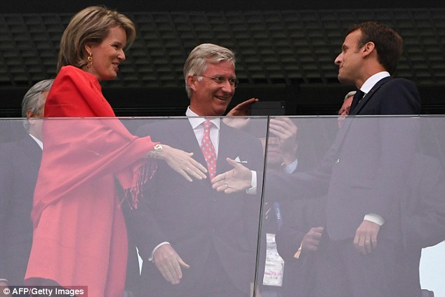 French President Emmanuel Macron greets Belgium's Queen Mathilde and King Philippe as they prepare to watch their countries do battle 